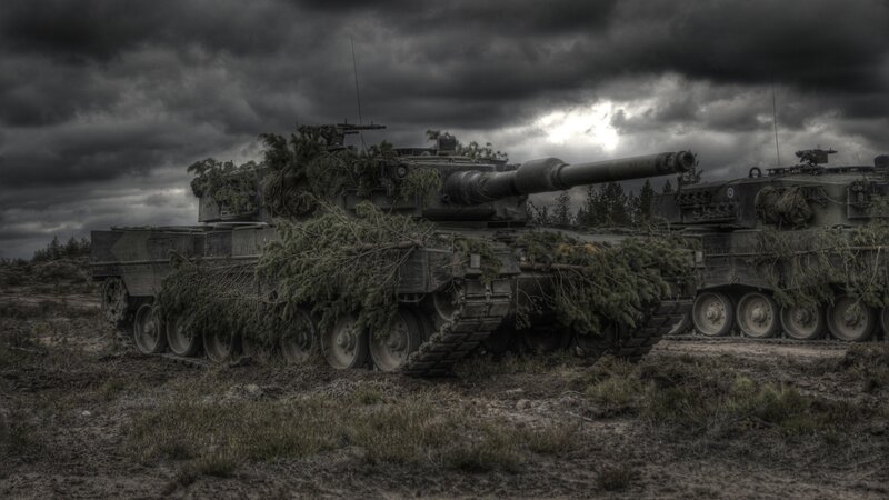 Camouflaged Tanks in Field