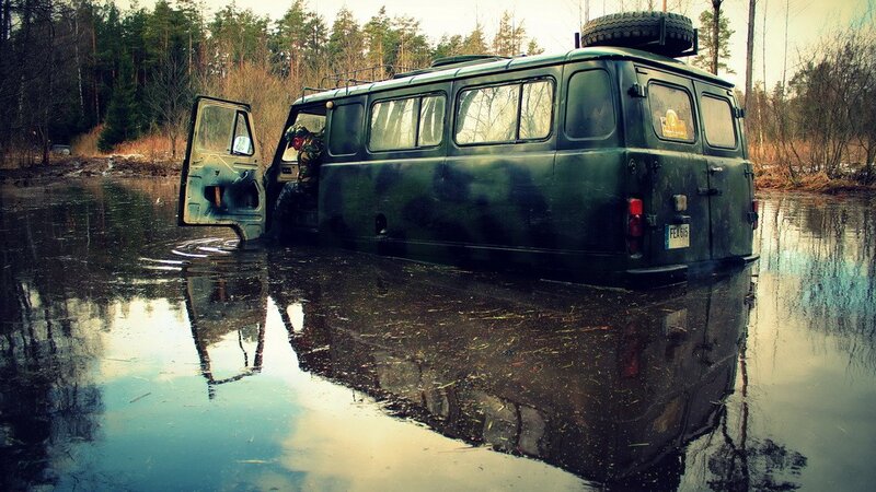 Camouflaged van in flooded forest