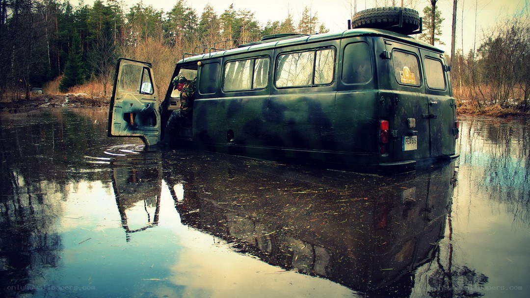Camouflaged van in flooded forest