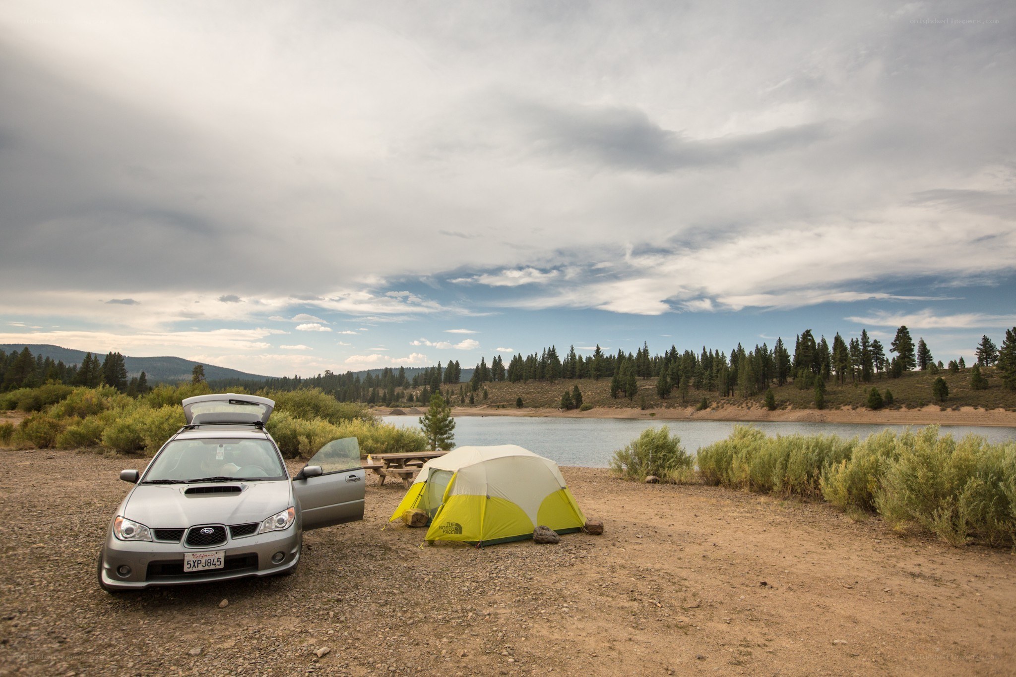 Camping by a lake with a car