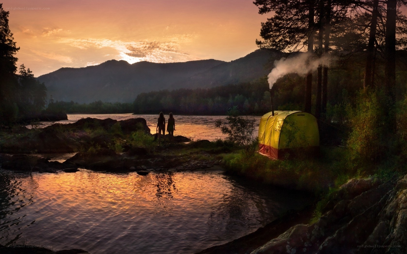 Camping by the river at sunset