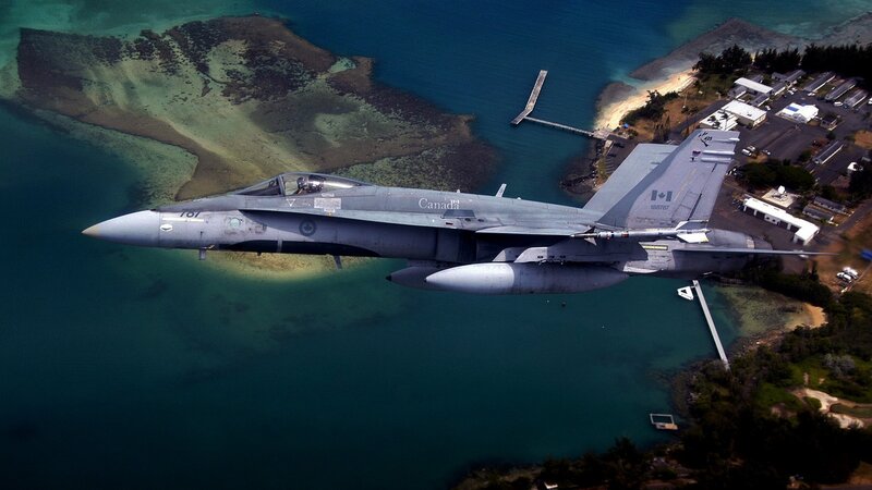 Canadian fighter jet over coastal area