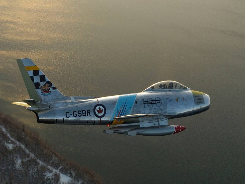 Canadian jet flying over water
