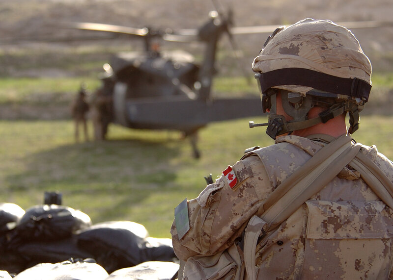 Canadian soldier near helicopter
