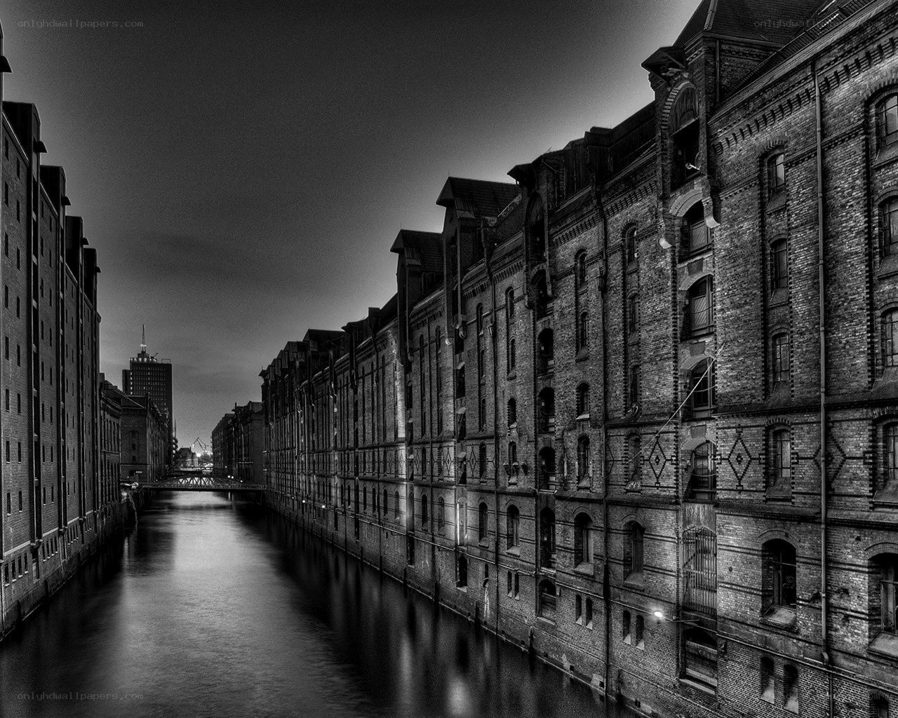 canal between brick buildings