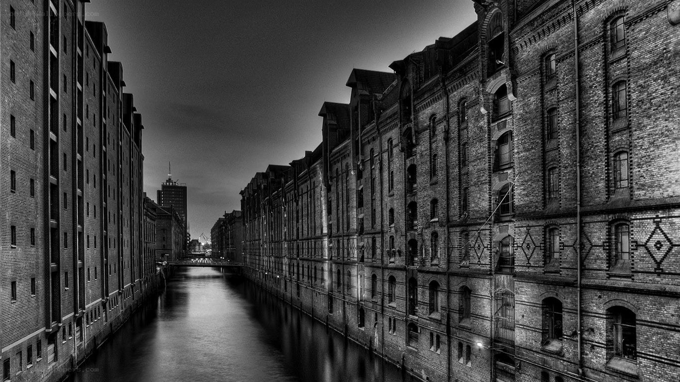 canal between brick buildings