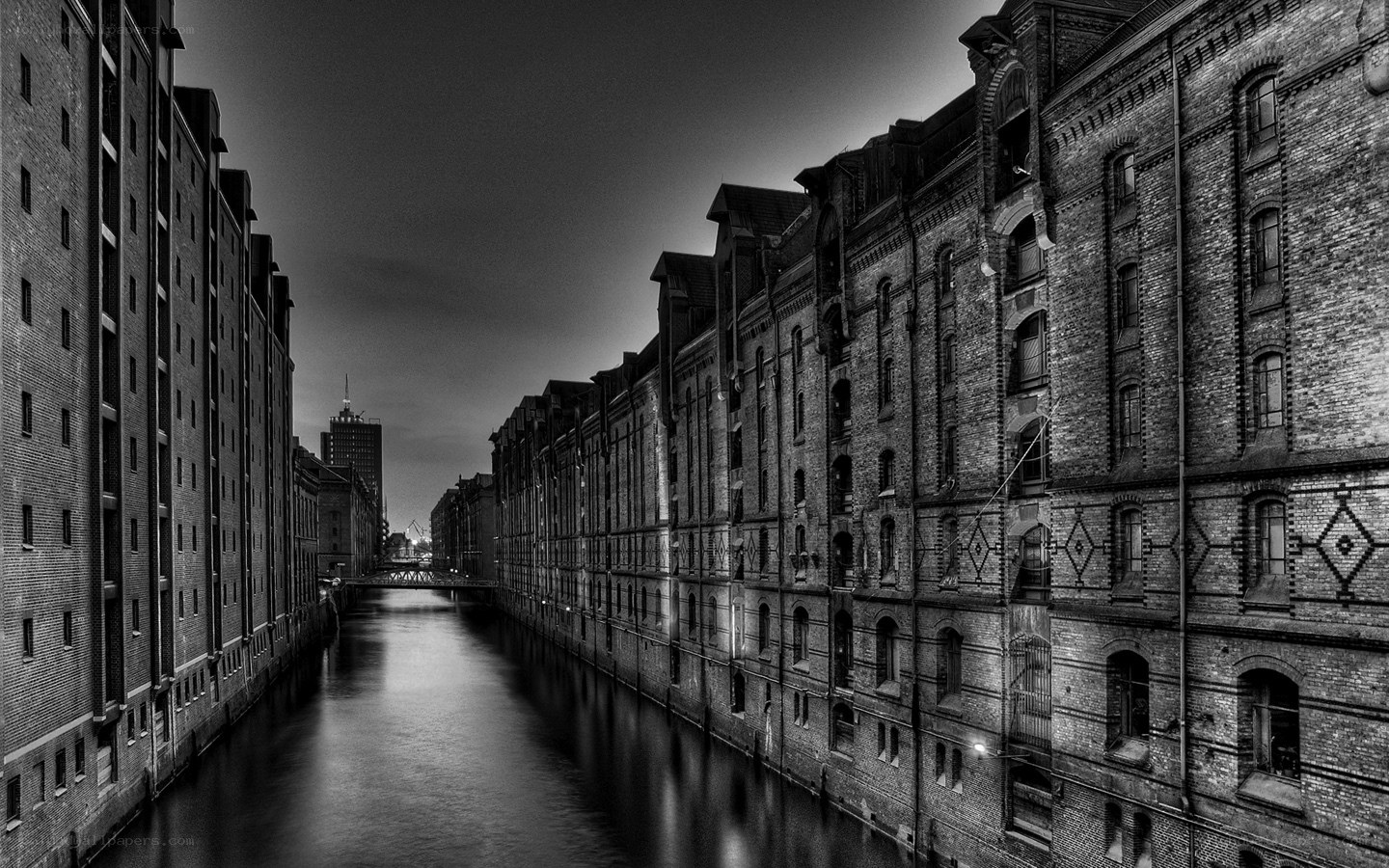 canal between brick warehouses