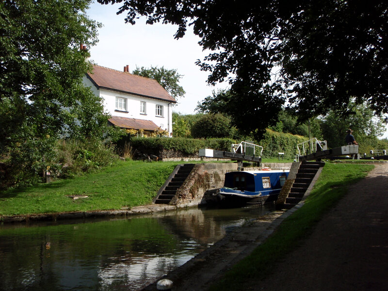 Canal boat at lock with house