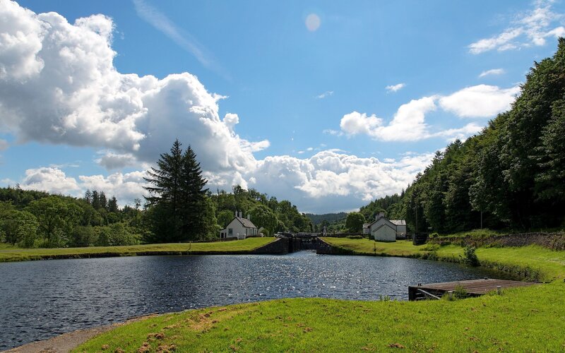 Canal lock with houses and trees