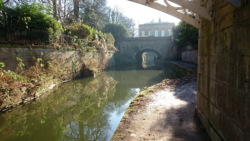 Canal under Stone Bridge — Green, Serene, Afternoon