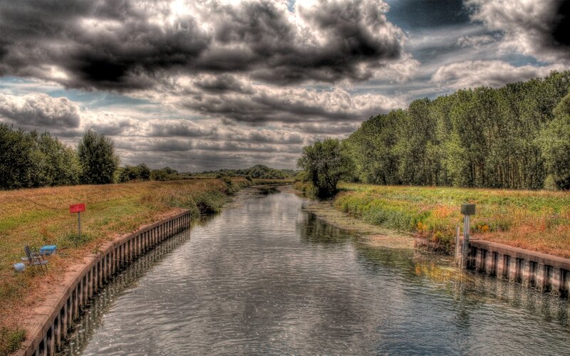 Canal under stormy sky