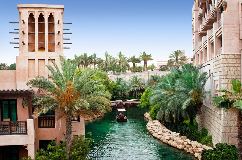 Canal with Boats and Palm Trees