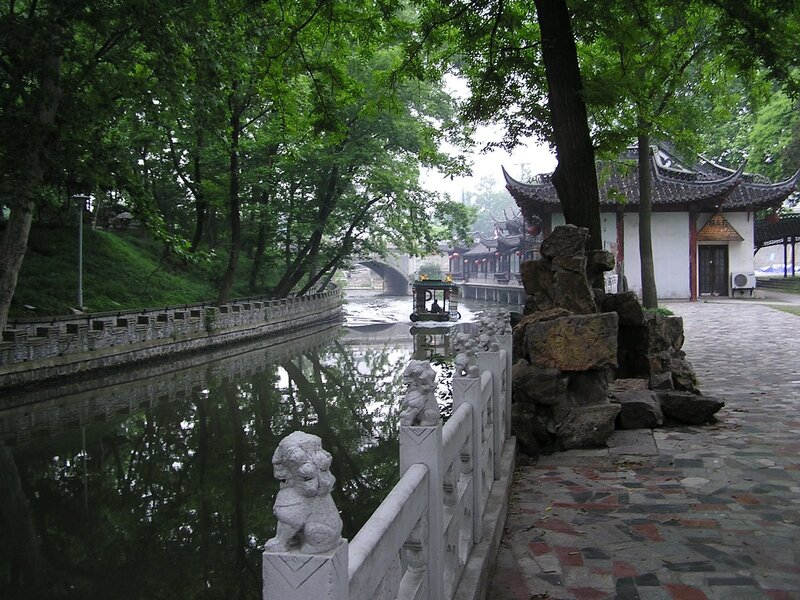 canal with traditional boat and bridge