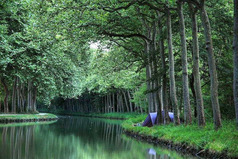 Canal with trees and tent