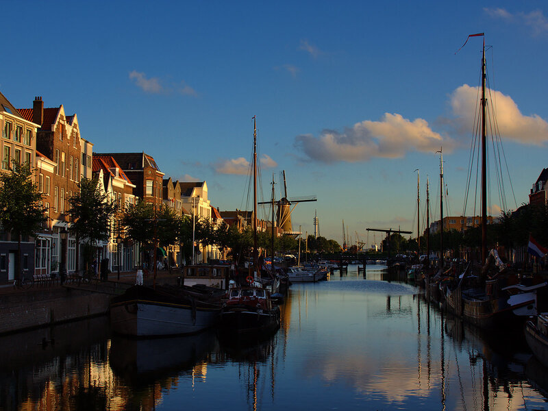 Canal with windmill at sunset