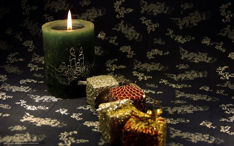 Candle and gifts on patterned cloth