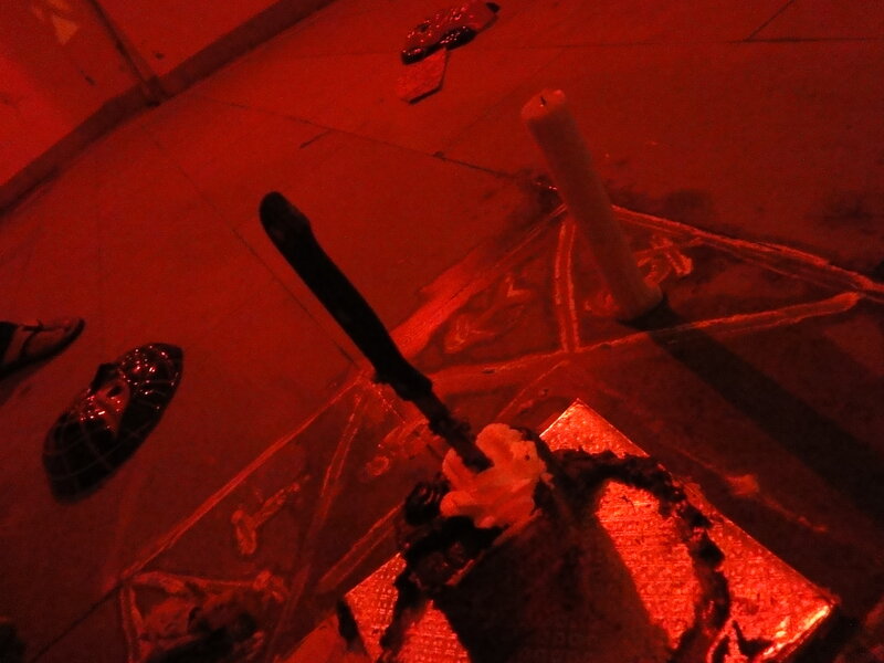 Candle and knife on floor