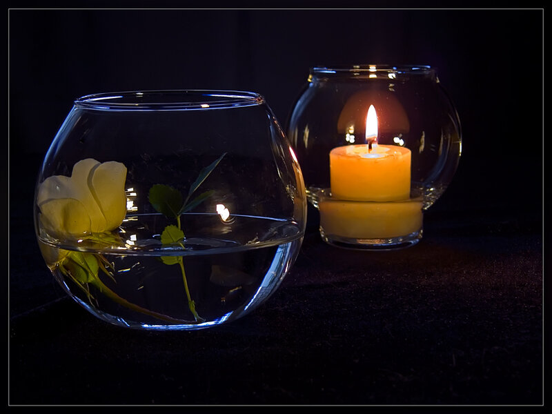 Candle and rose in glass bowls