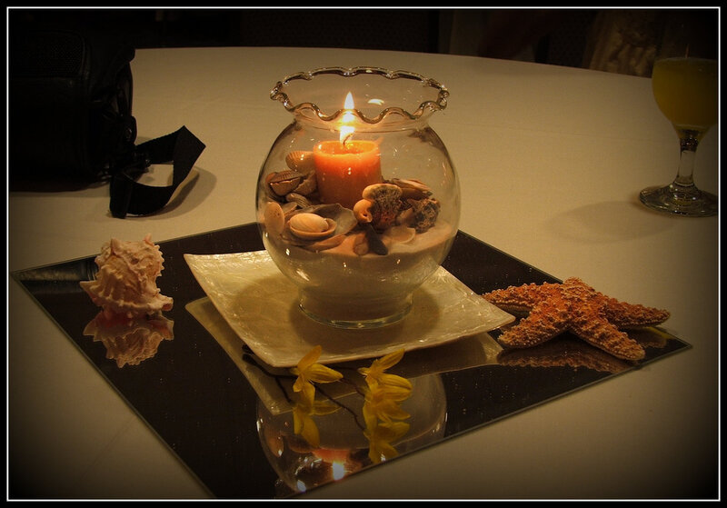 candle centerpiece with seashells