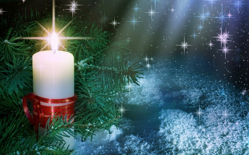 Candle in snowy forest