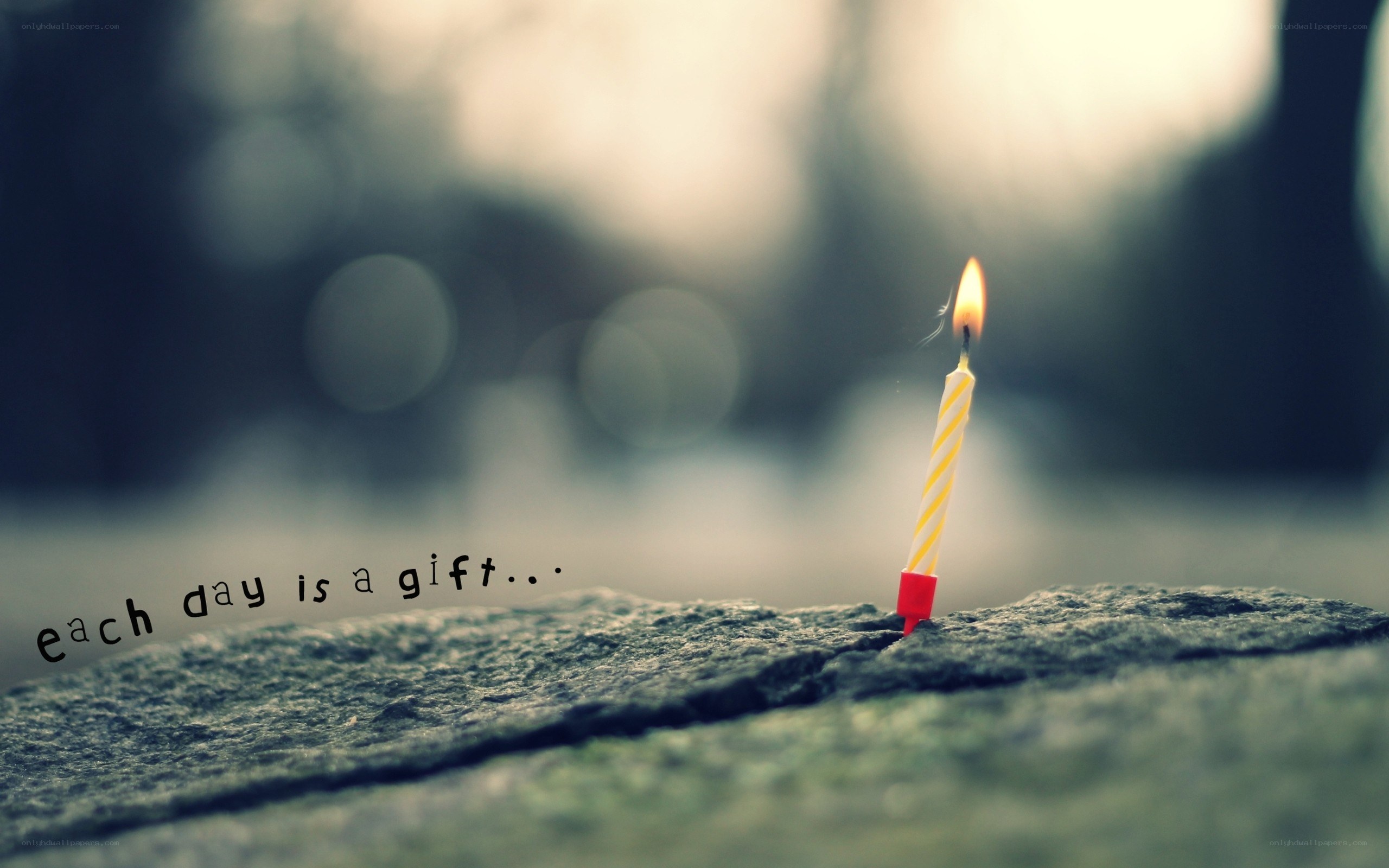 candle on stone with quote