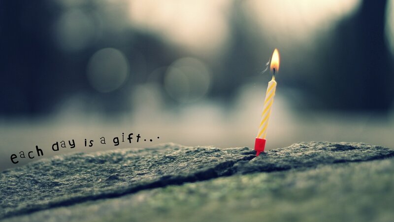 candle on stone with quote