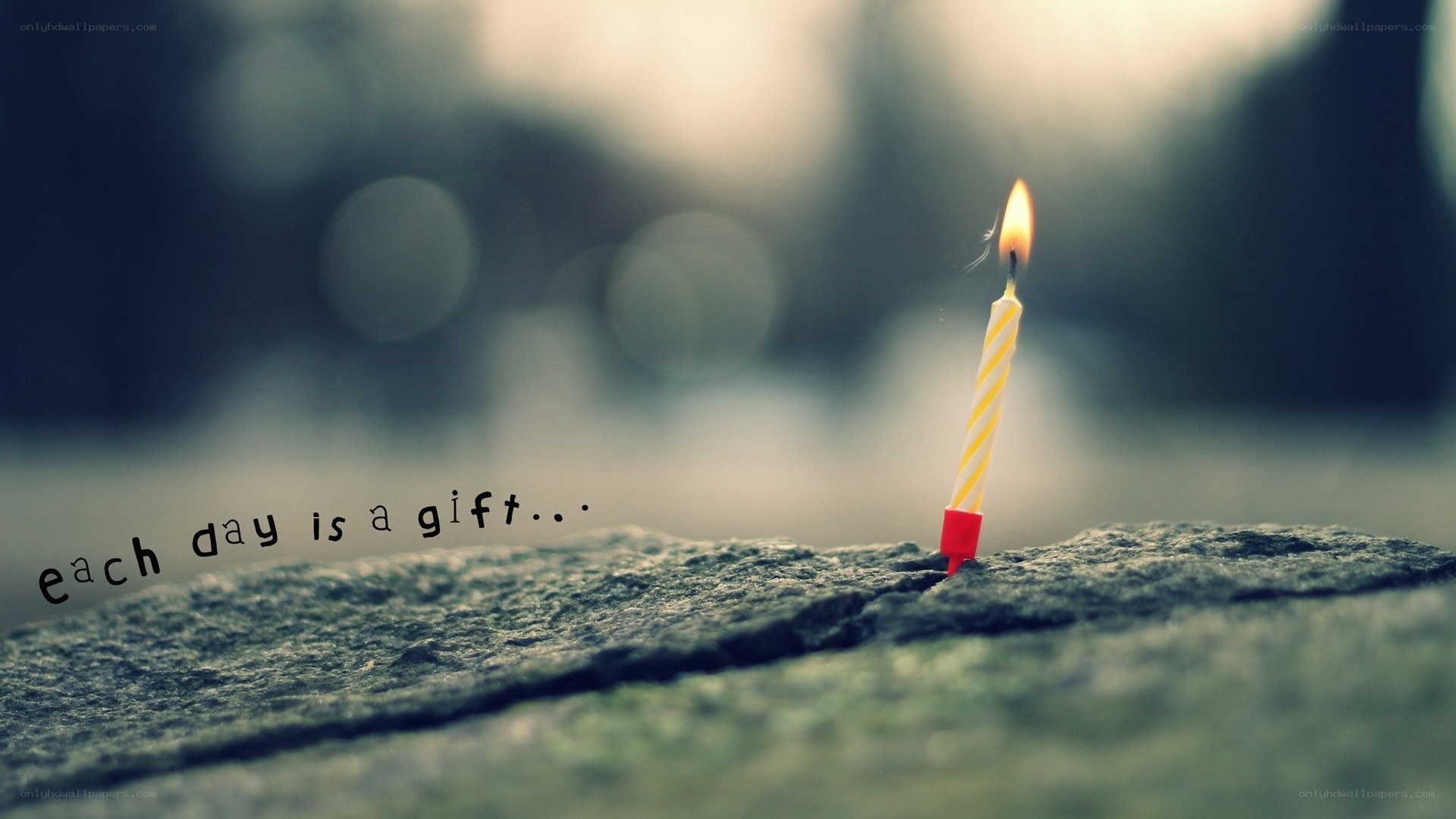 candle on stone with quote