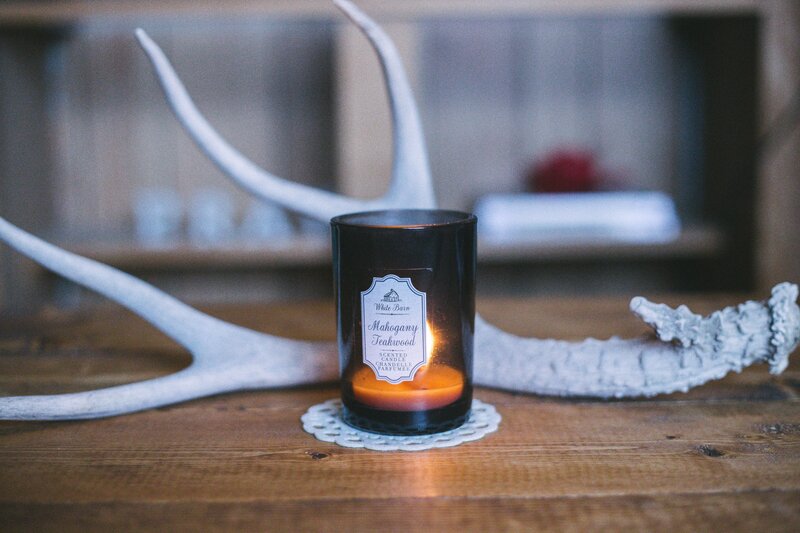 candle with antlers on wood