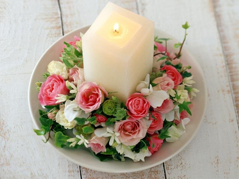 candle with floral arrangement