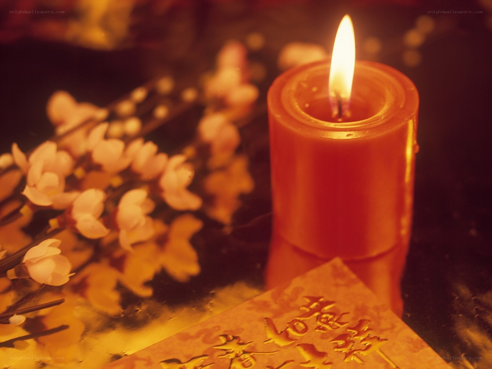 Candle with flowers and envelope