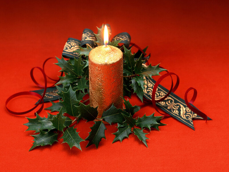 Candle with holly and ribbon