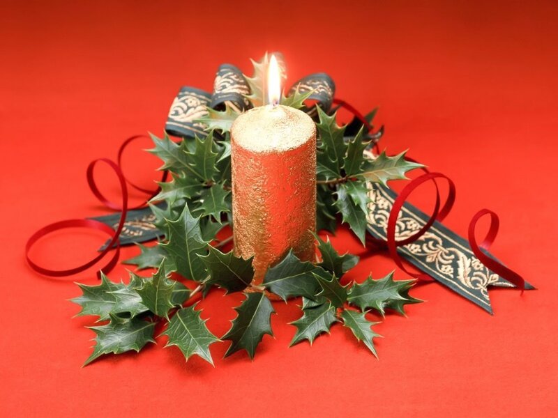 candle with holly decoration