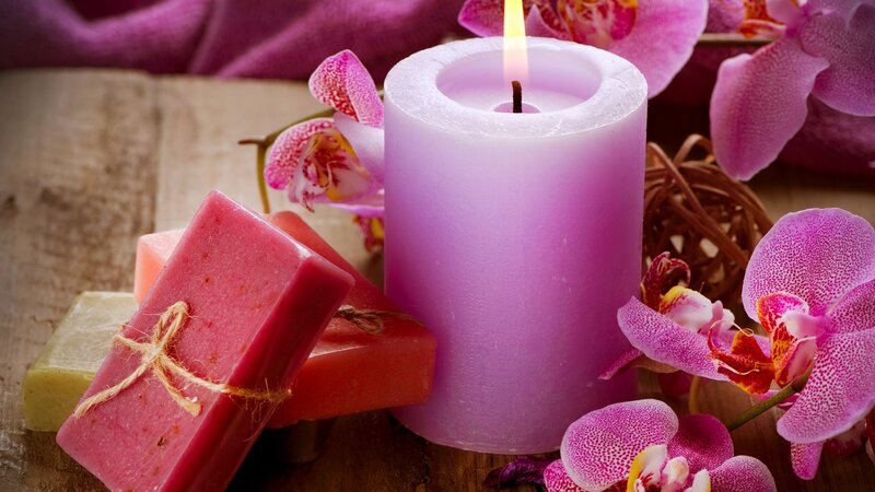 candle with orchids and soap