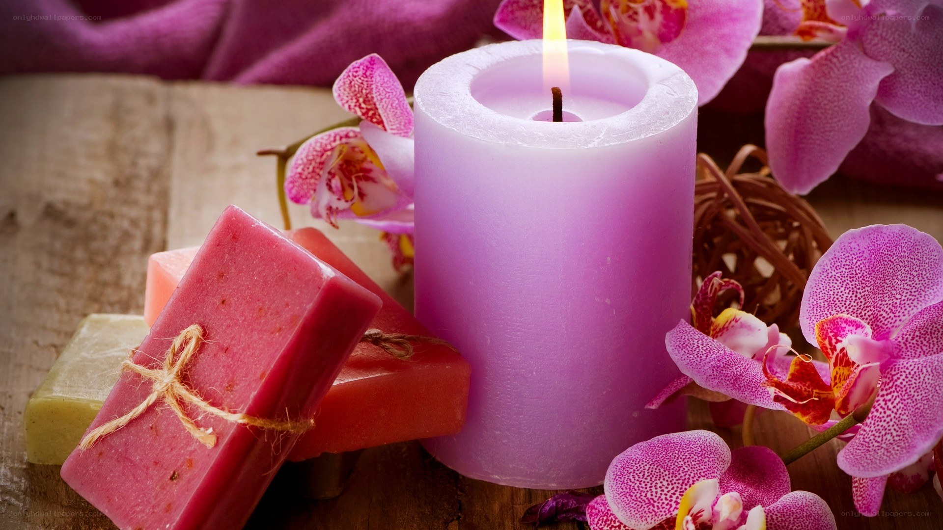 candle with orchids and soap