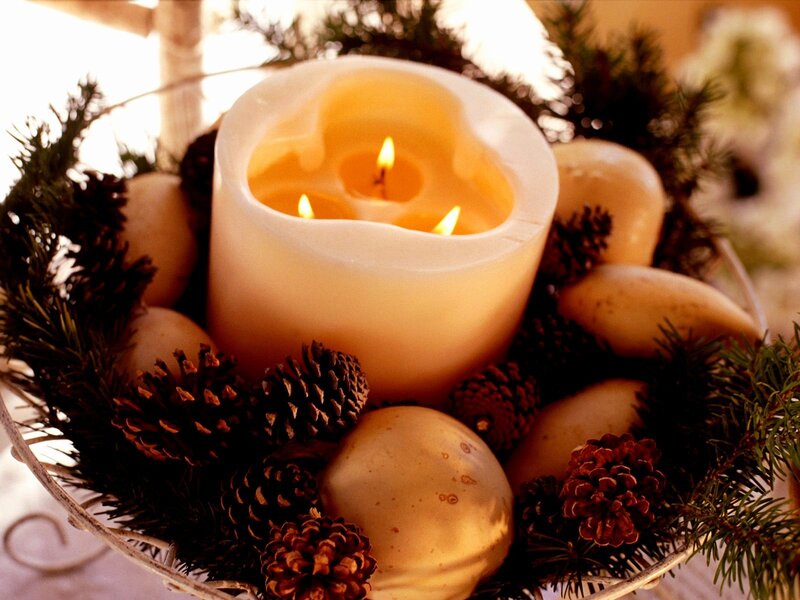 candle with pinecones