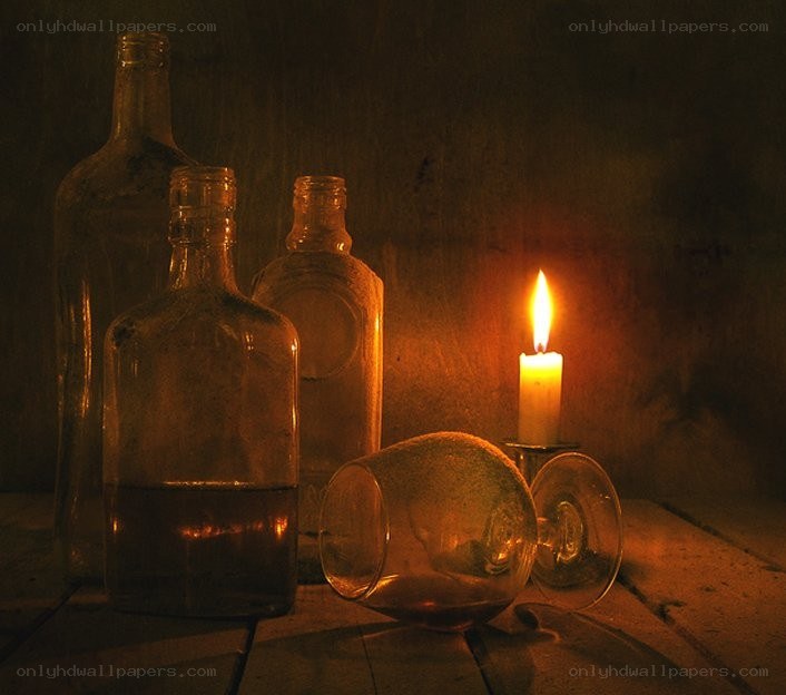 candlelit bottles and glass