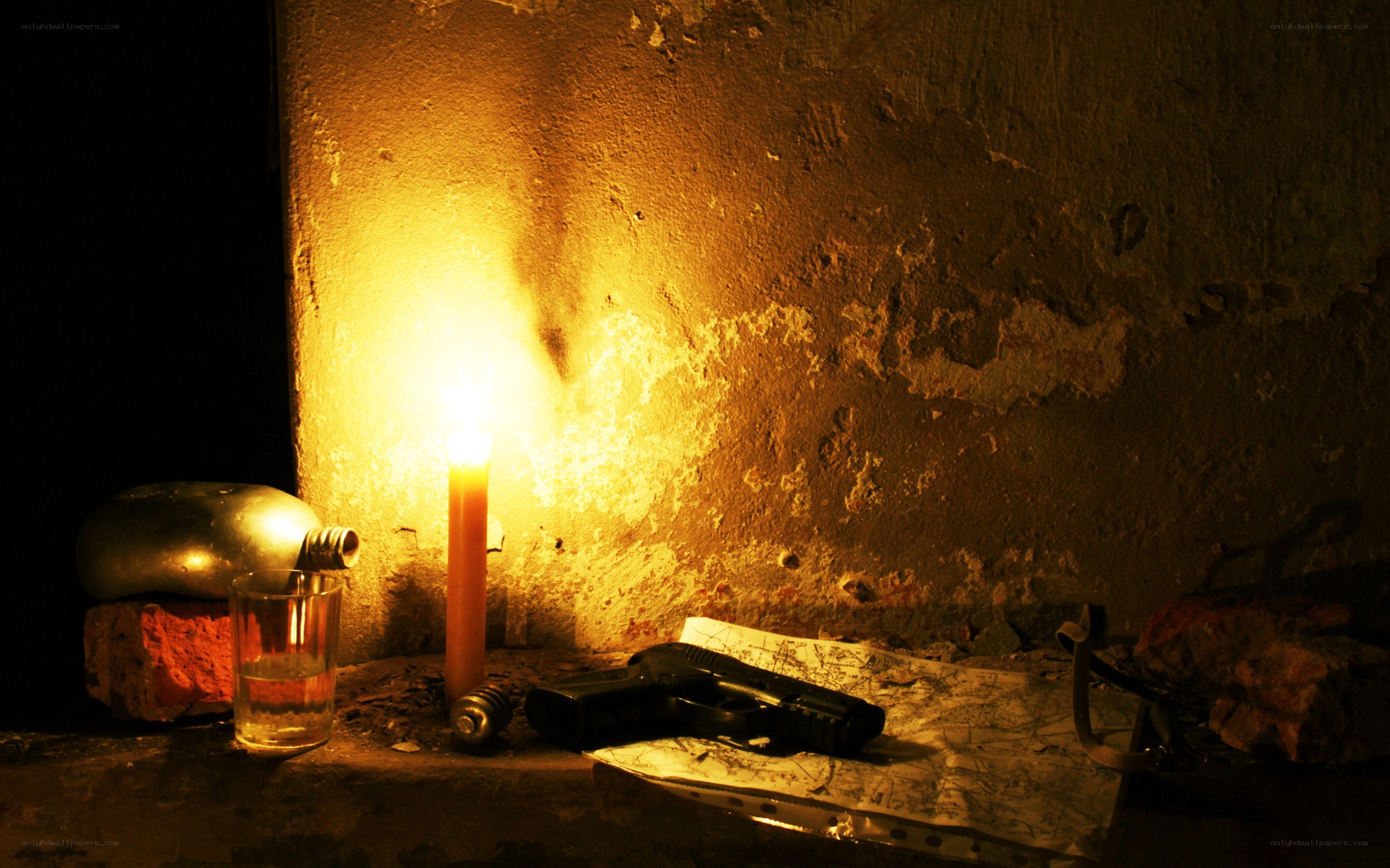 Candlelit scene with gun and map