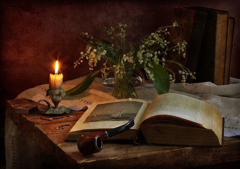 candlelit still life with books