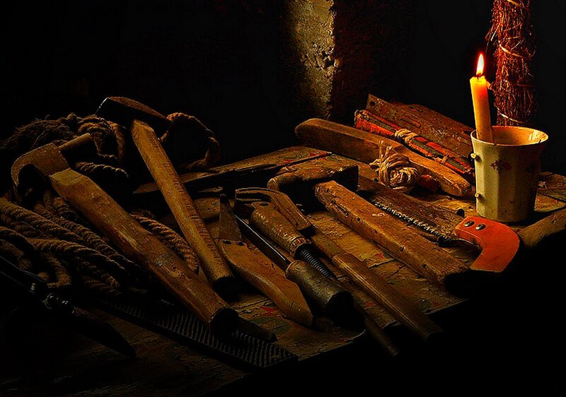 Candlelit tools on a workbench