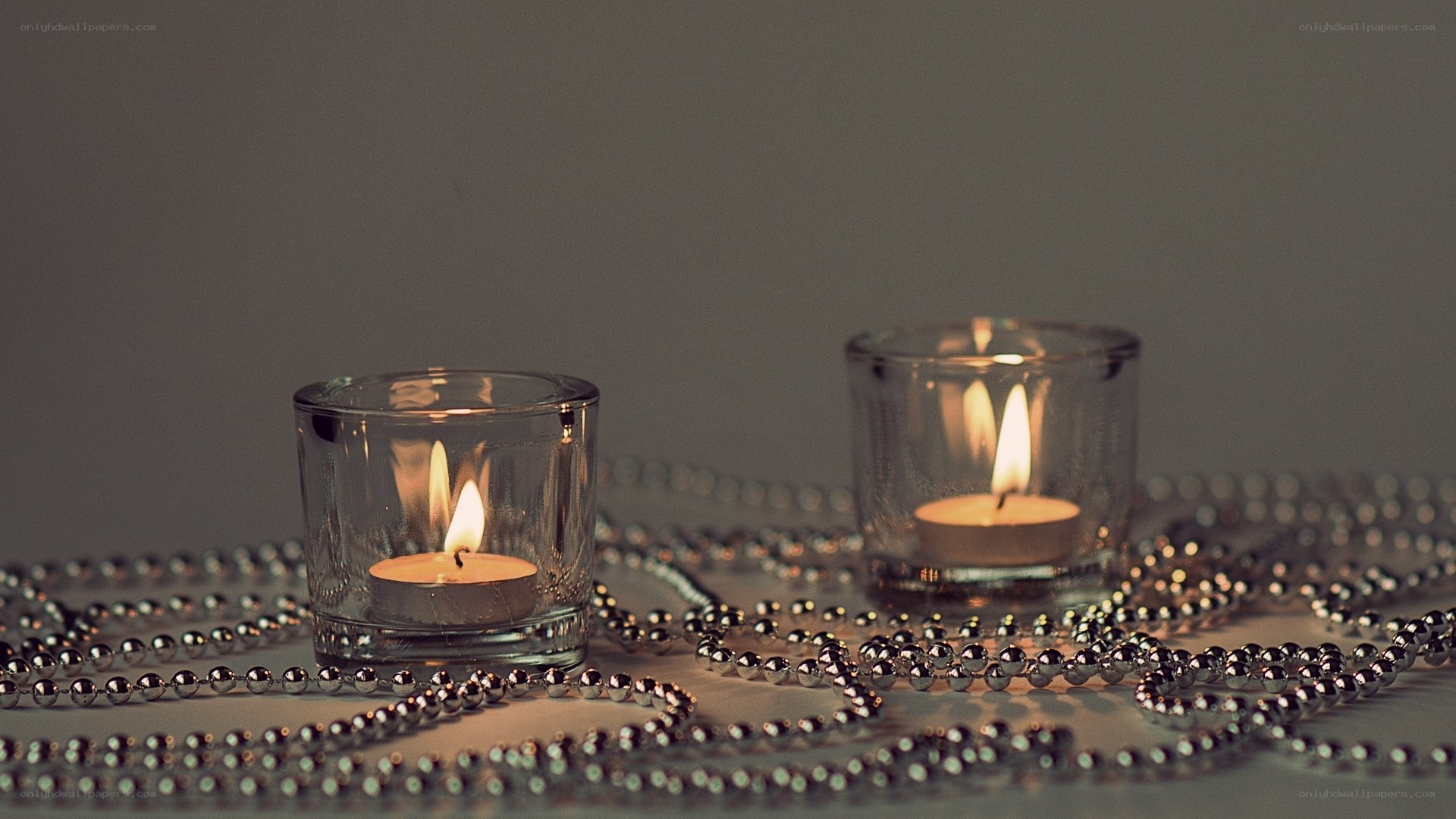 Candles and beads on table