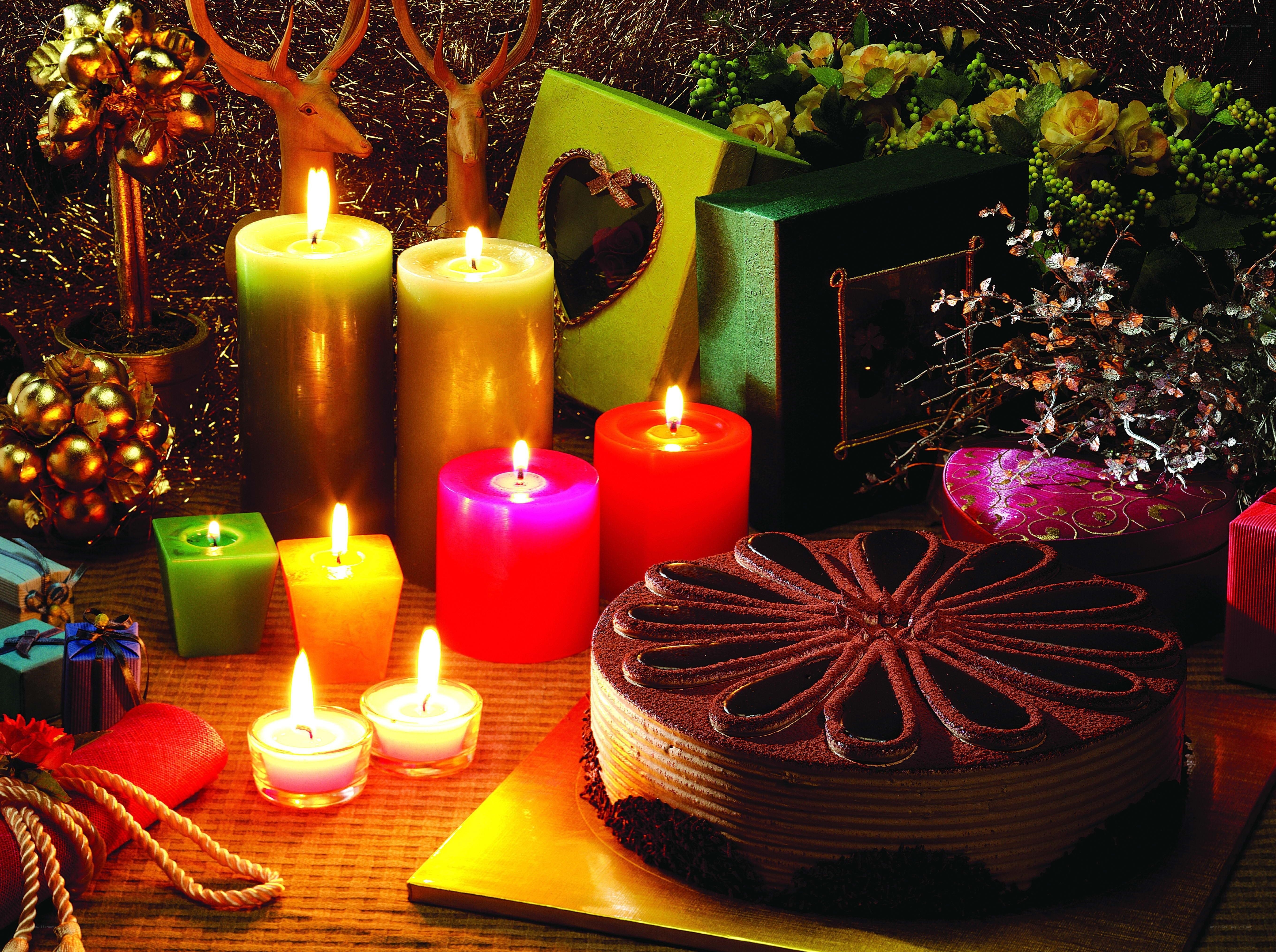Candles and cake on festive table