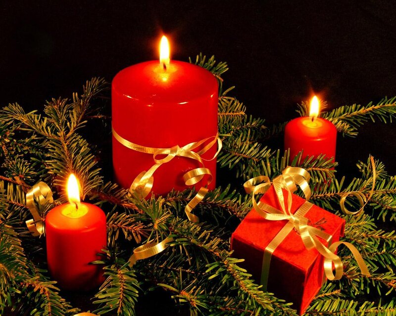 Candles and gifts on fir branches