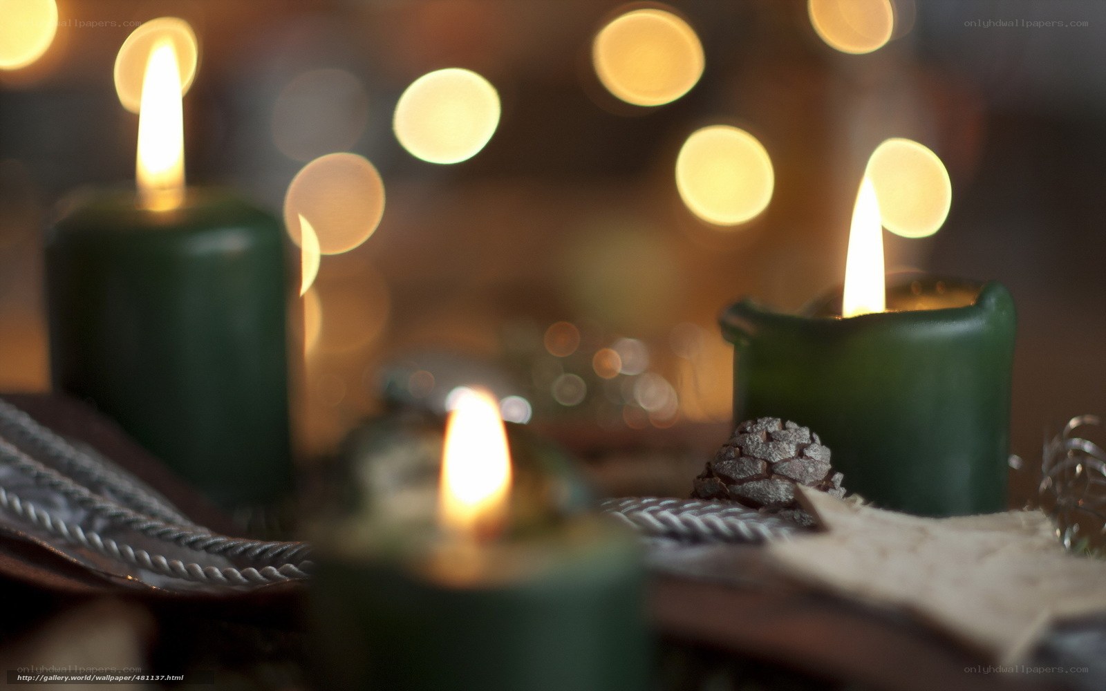 Candles and pinecones in warm light
