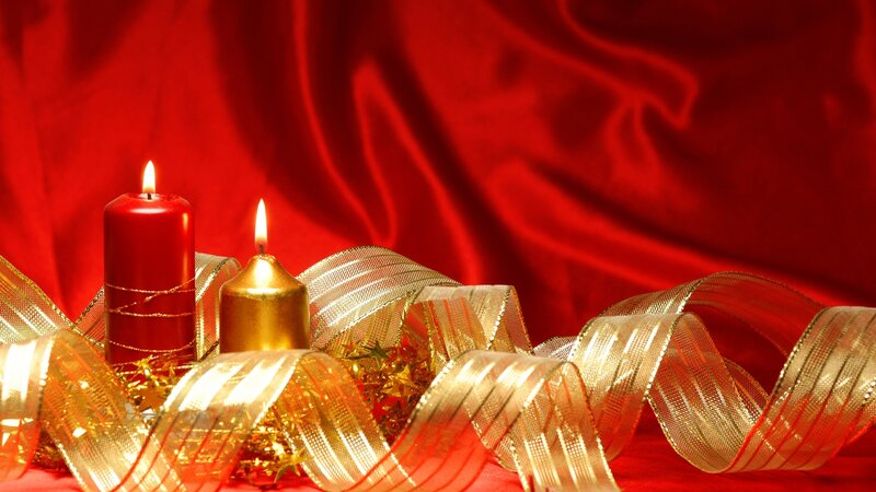 Candles and ribbons on red cloth