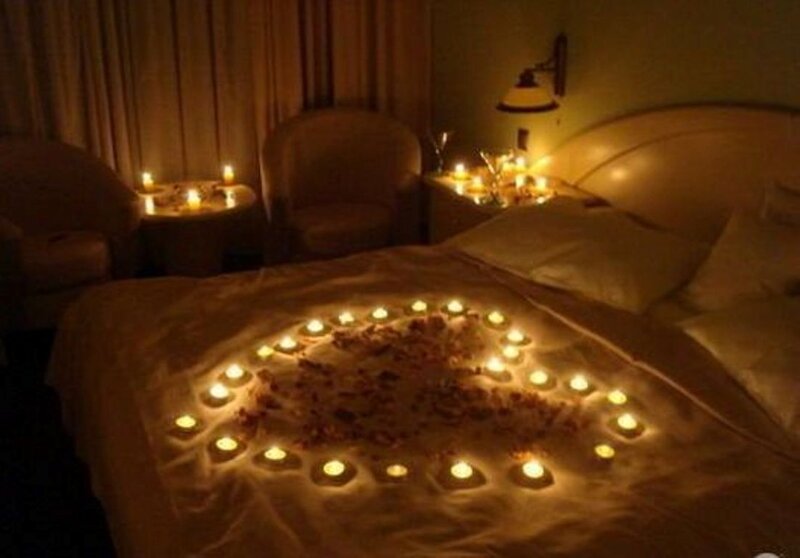 Candles and Rose Petals on Bed
