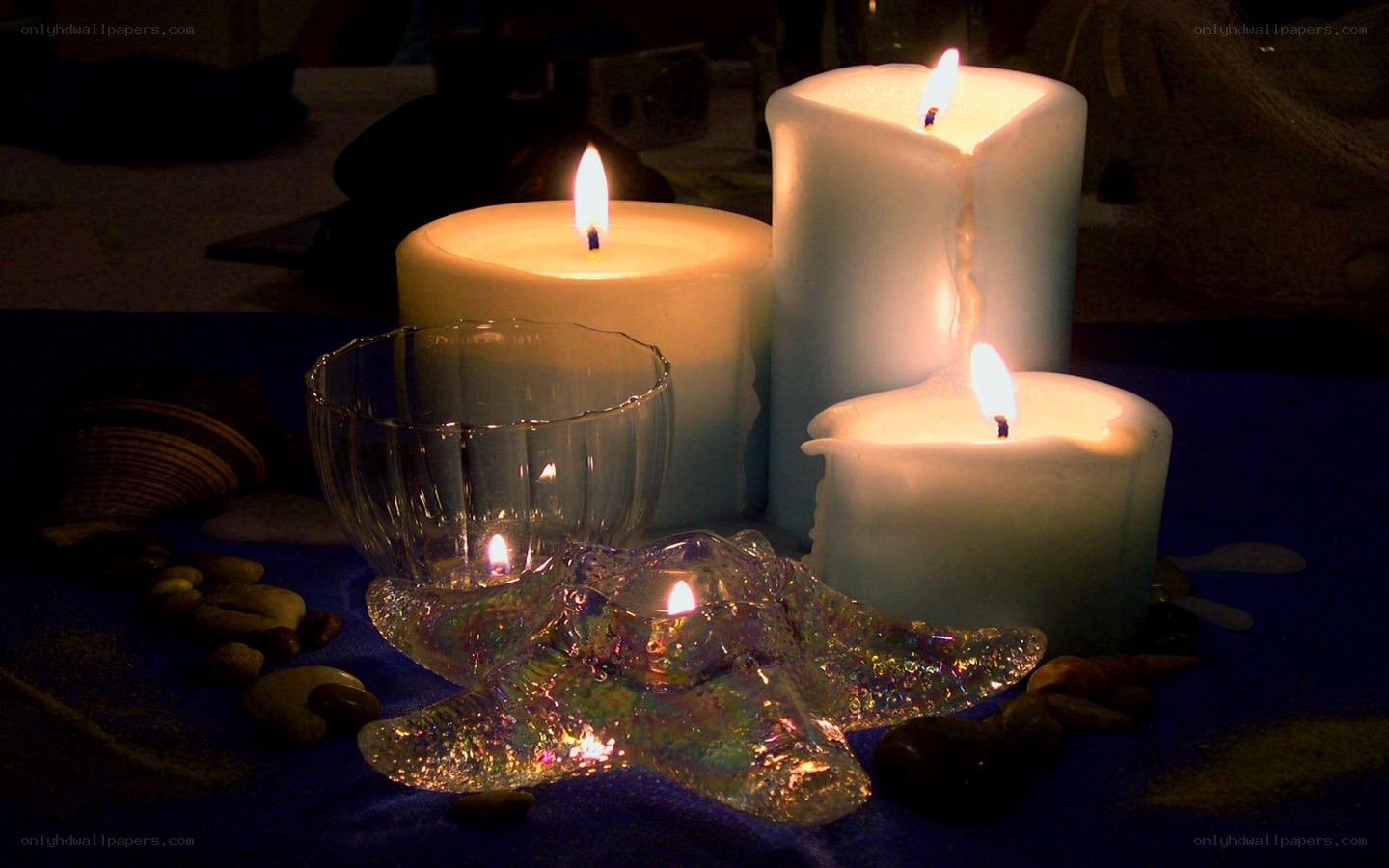 Candles and seashells on blue cloth