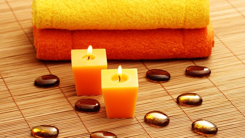 Candles and spa stones on mat