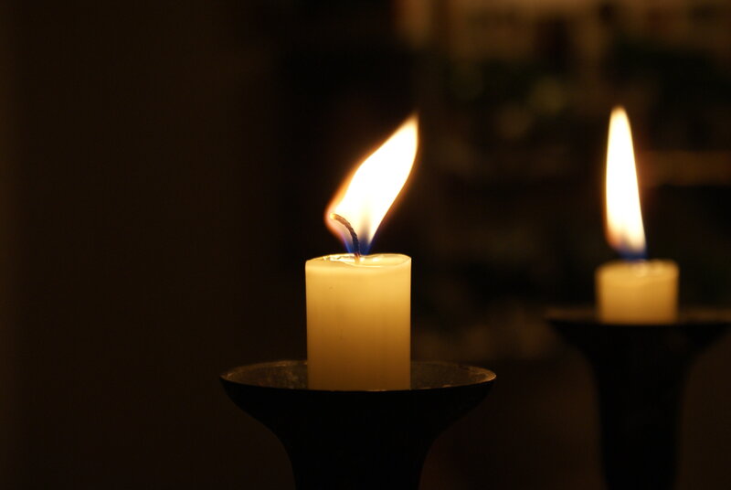 Candles burning in darkness