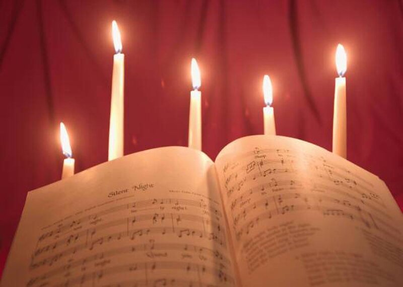 Candles illuminate sheet music