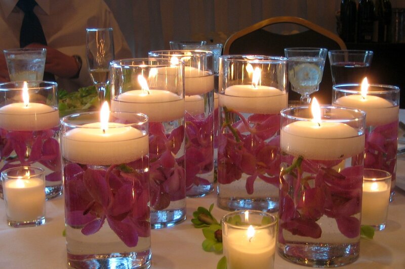 Candles with flowers in glass vases